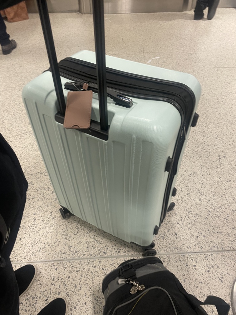 The mint green suitcase referred in the post, picture taken in airport corridor